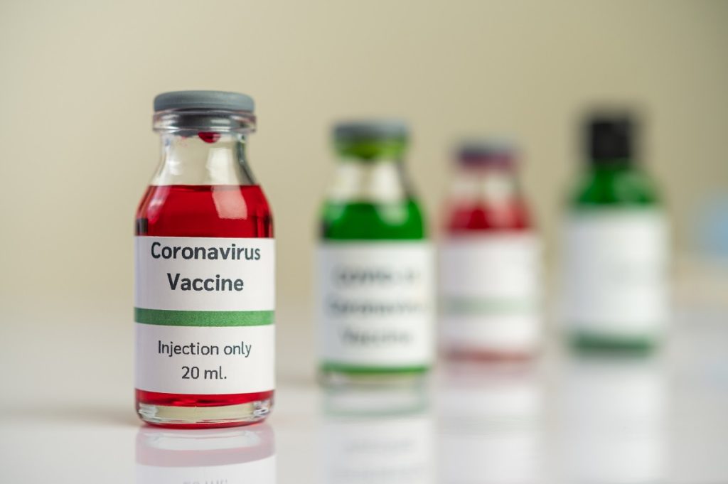 vaccine against covid 19 is red green bottles placed floor 1