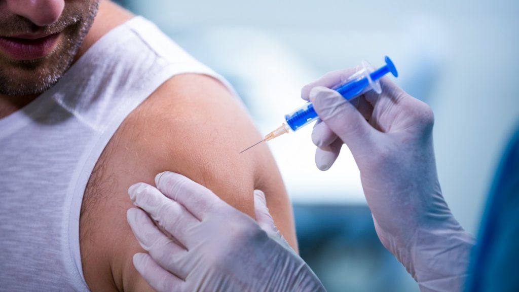 female doctor giving injection patient