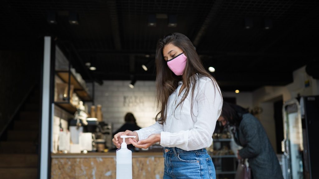 woman using sanitizer gel cleans hands coronavirus virus cafe