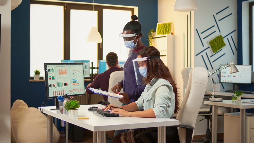 businesswoman with protective mask discussing with EL7VNK4 1