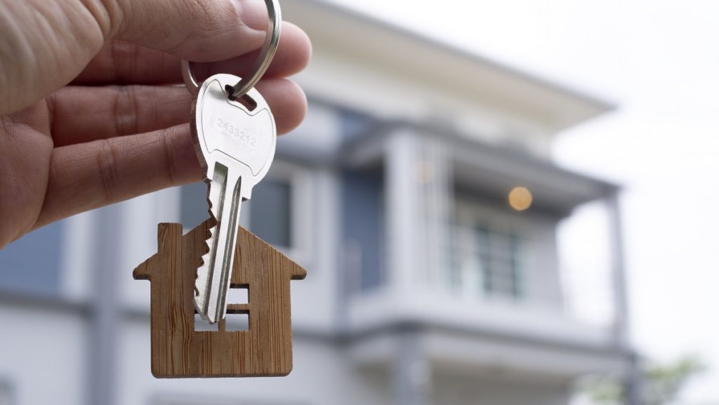 landlord unlocks house key new home real estate agents sales agents 1