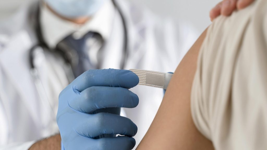 man putting bandage young woman s arm