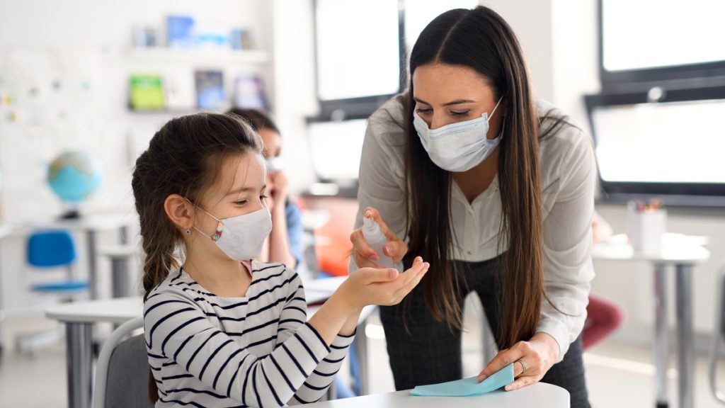 teacher and children with face mask back at school SBVEBG2