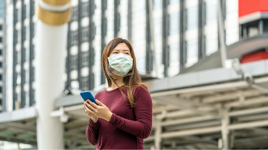 asian woman hand using smart mobile phone with saf PEJ2AEK