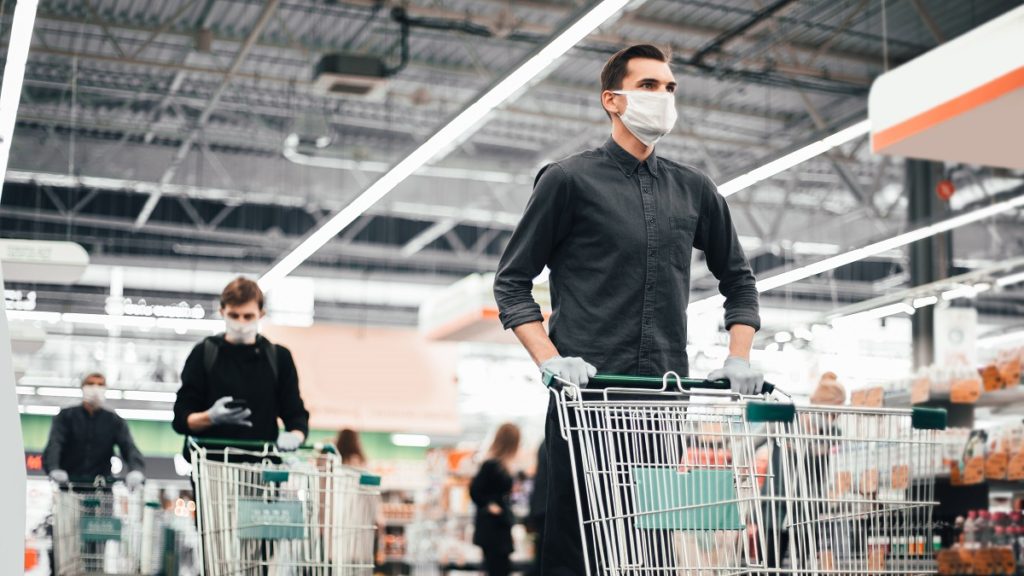 close up young man protective mask with shopping cart