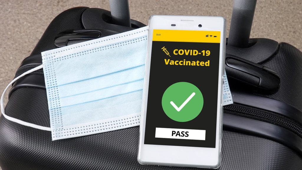 smartphone with digital vaccination certificate covid 19 luggage