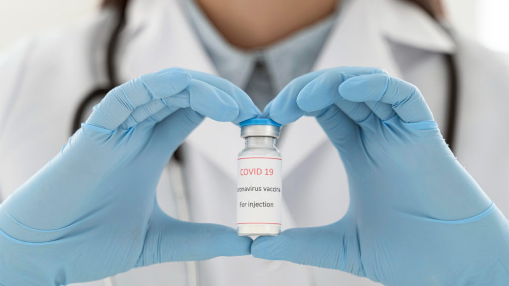 doctor holding vaccine recipient copy