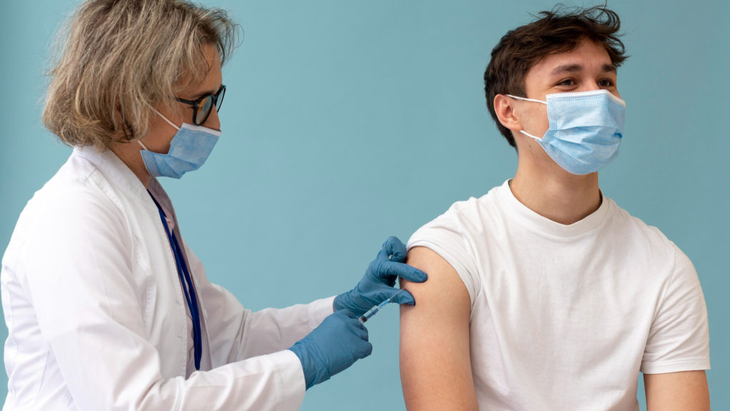 medium shot man getting vaccine copy