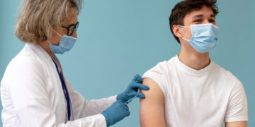 medium shot man getting vaccine copy
