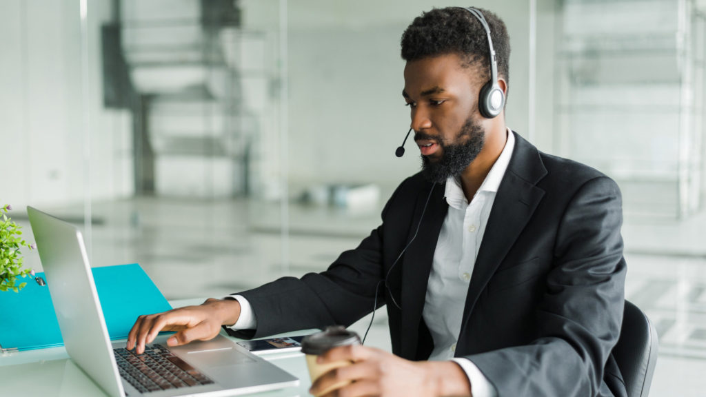 african american man customer support operator with hands free headset working office copy copy