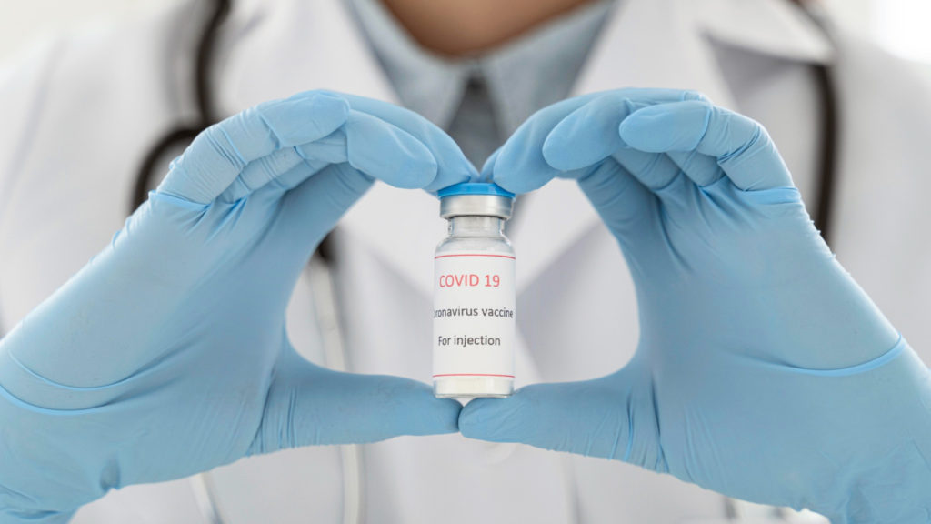 doctor holding vaccine recipient copy