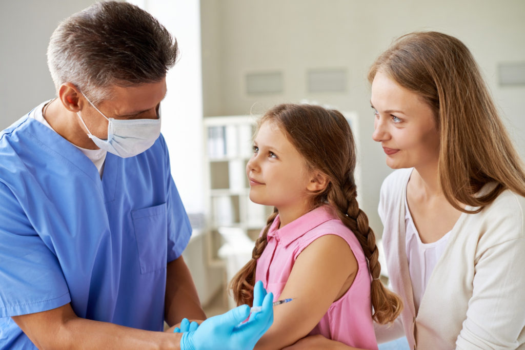 girl receiving vaccine medical office copy