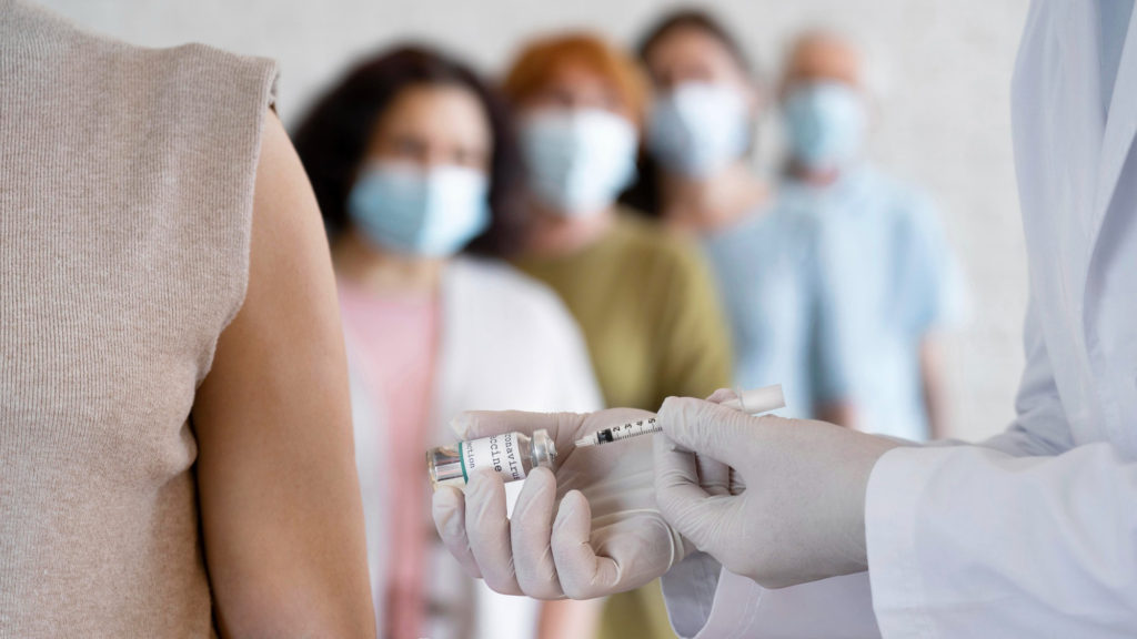 woman getting vaccine shot by doctor copy