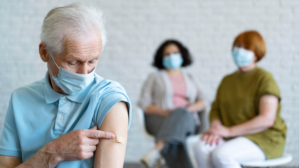 man with bandage arm after vaccination