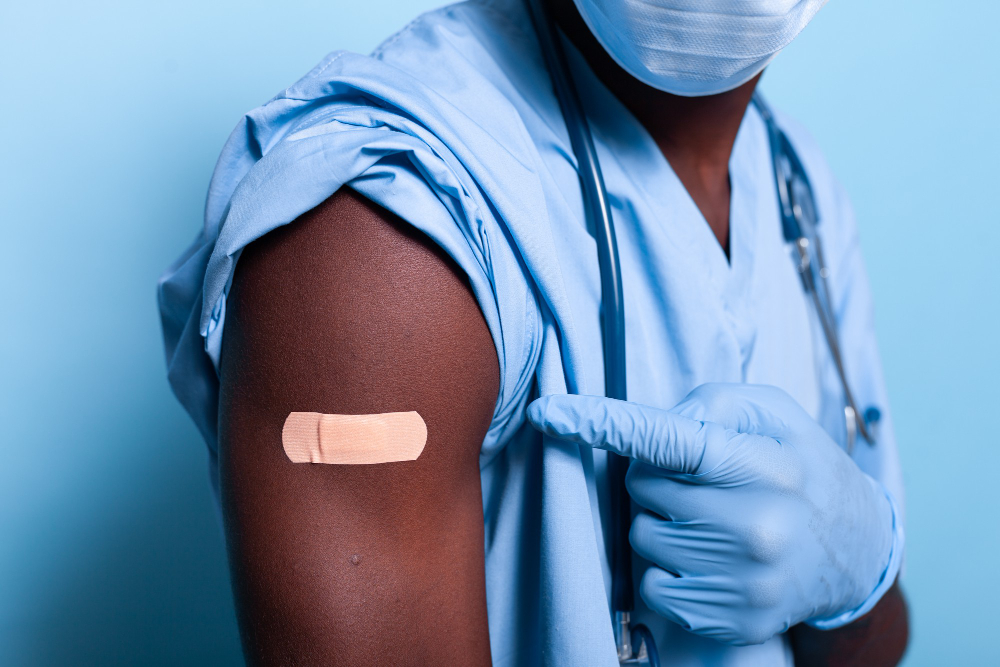 close up bandaged vaccine shot arm man nurse