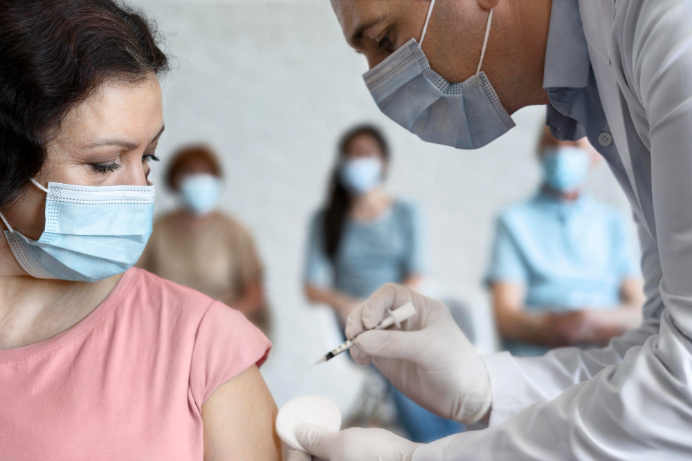 woman getting vaccine shot by male medic