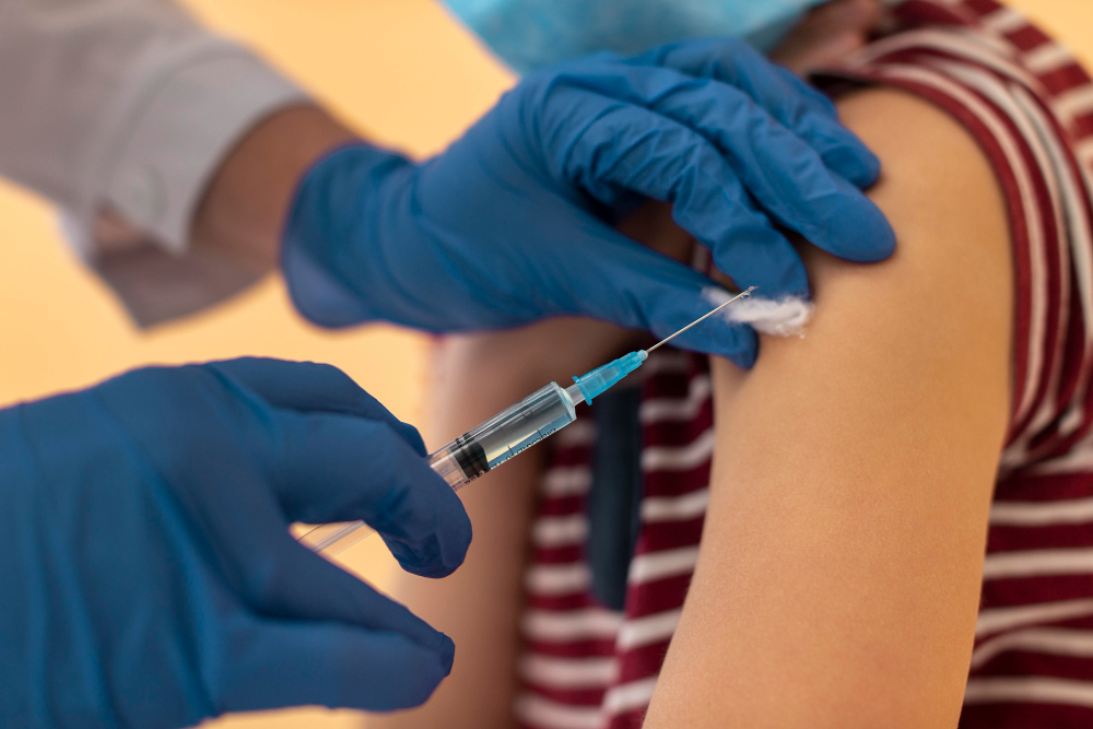 close up kid with face mask getting vaccine