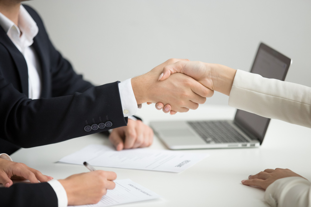 hr handshaking successful candidate getting hired new job closeup