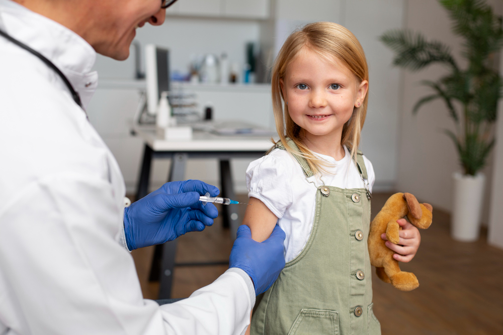 young girl getting vaccine doctor s office