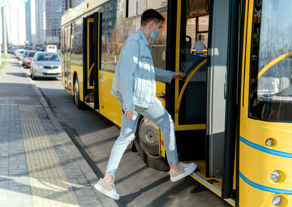 young man taking city bus copy