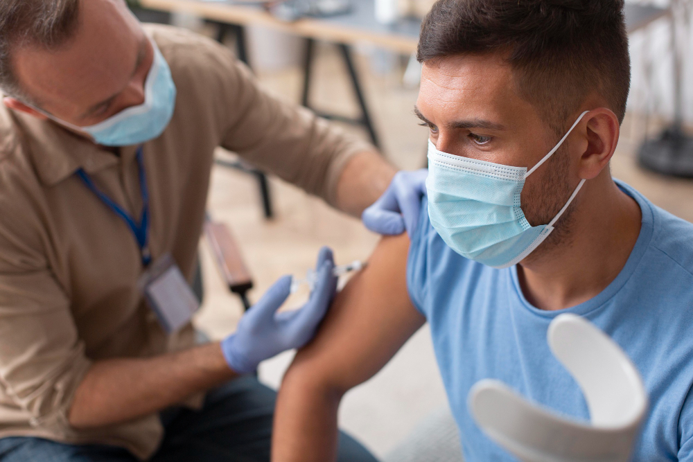 close up man with mask getting vaccinated