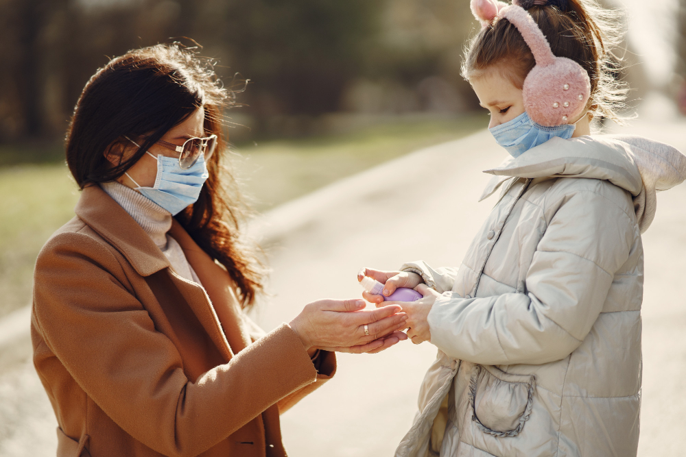 mother with daughter walks outside masks