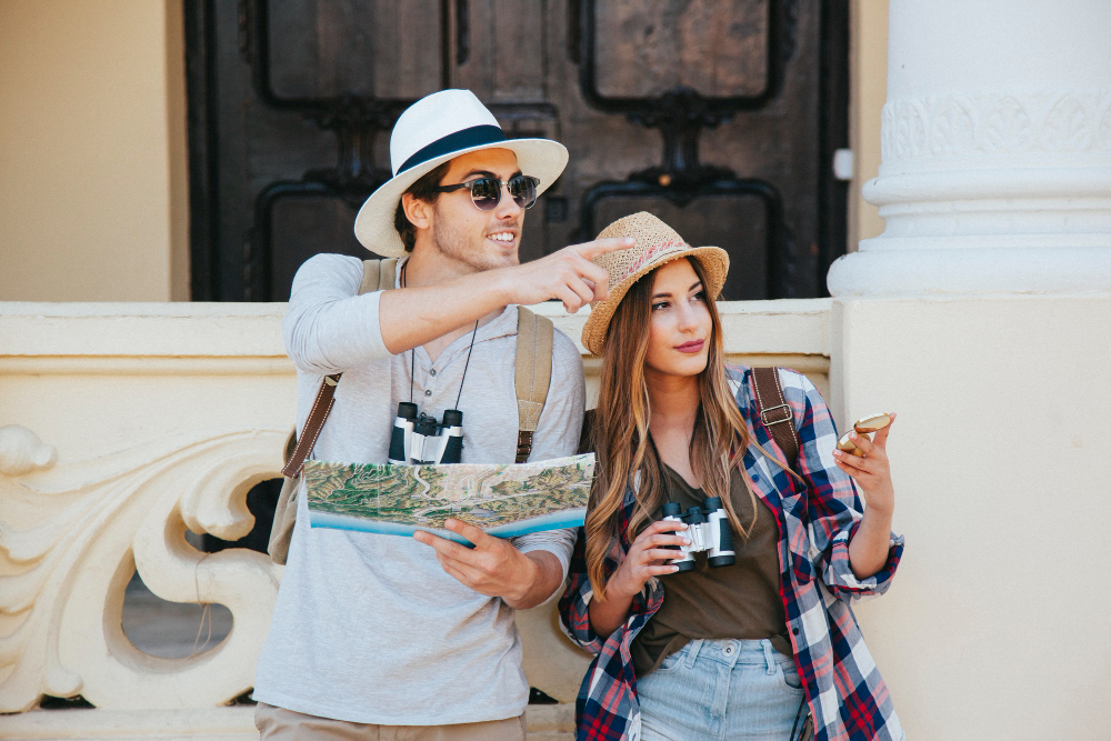 couple travelers pointing directions