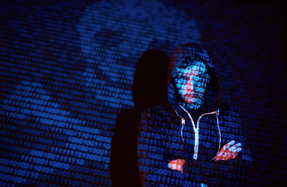 cyber attack with unrecognizable hooded hacker using virtual reality digital glitch effect