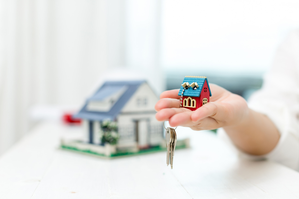 real estate agent with house model keys