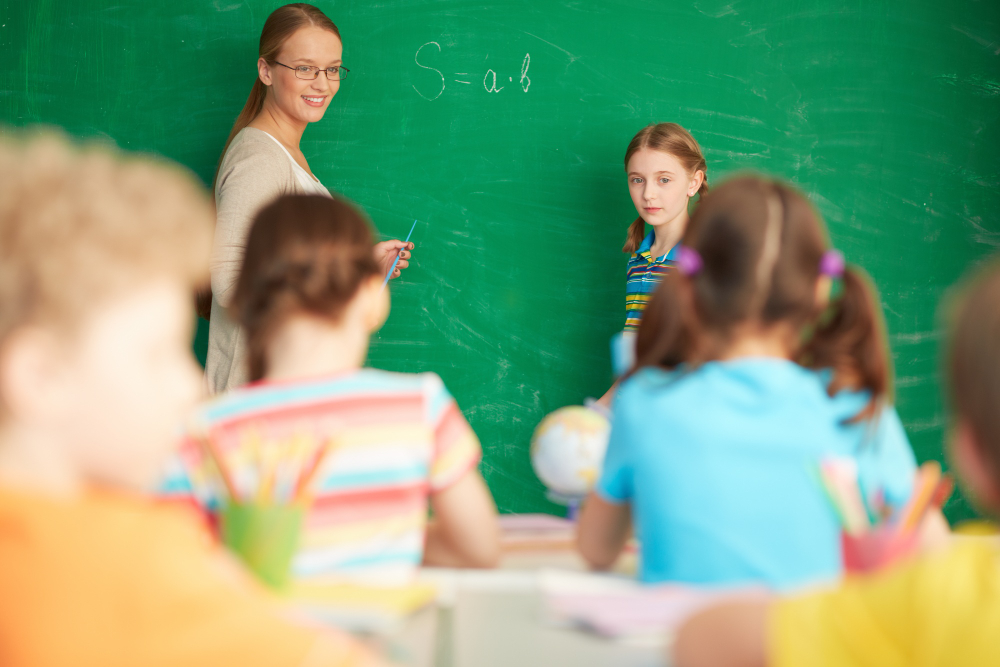 teacher explaining arithmetic blackboard