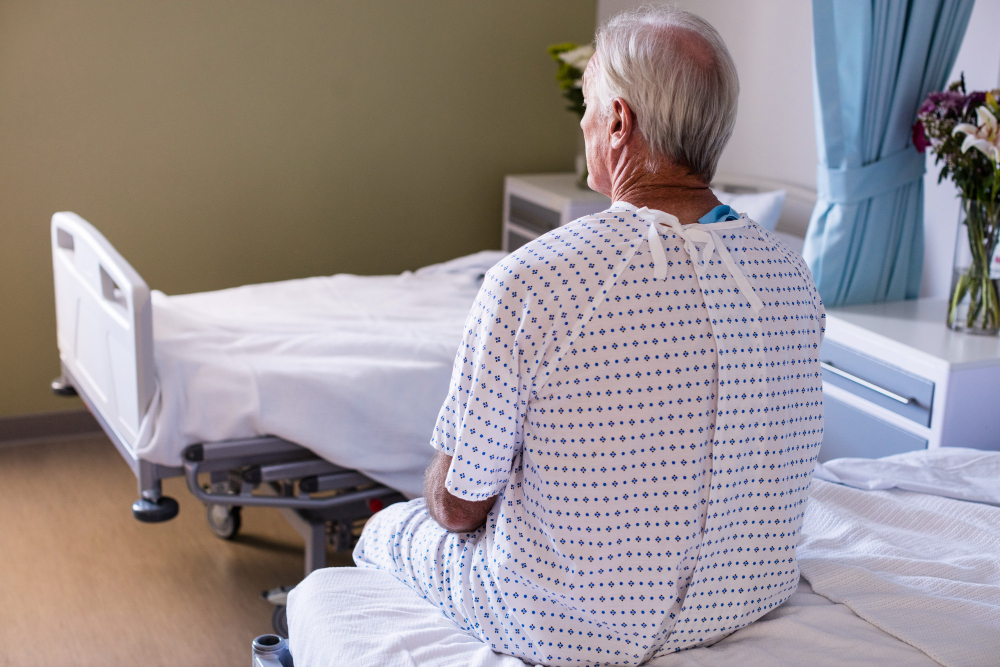 thoughtful male senior patient sitting ward