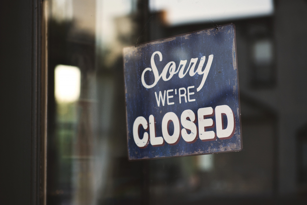 closeup shot blue white sorry we are closed wooden signage glass