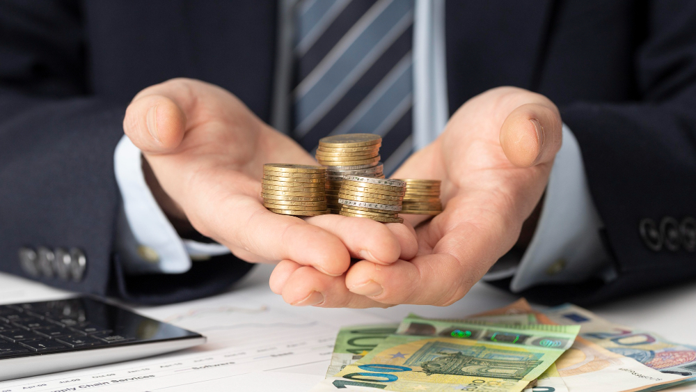 businessman holding bunch coins