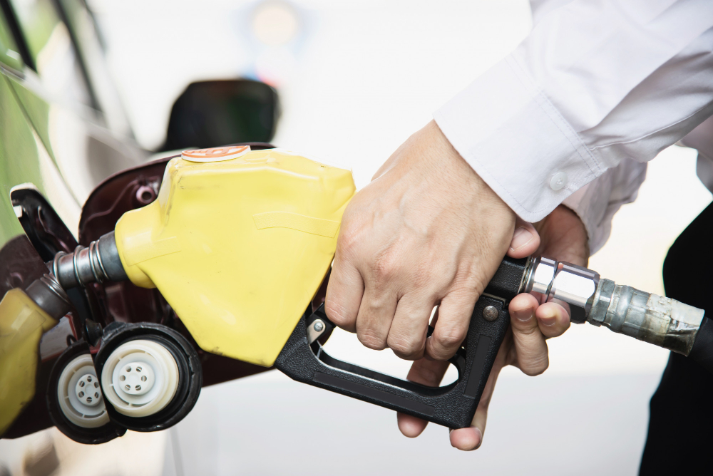 man putting gasoline fuel into his car pump gas station