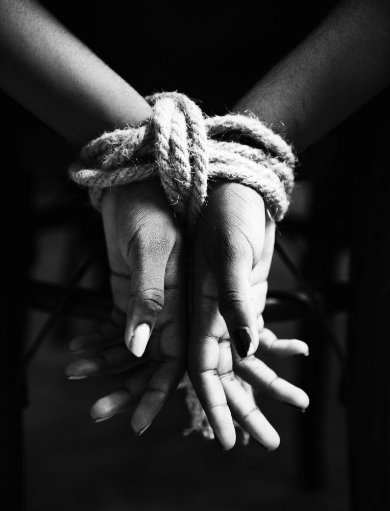 hands tied with rope around