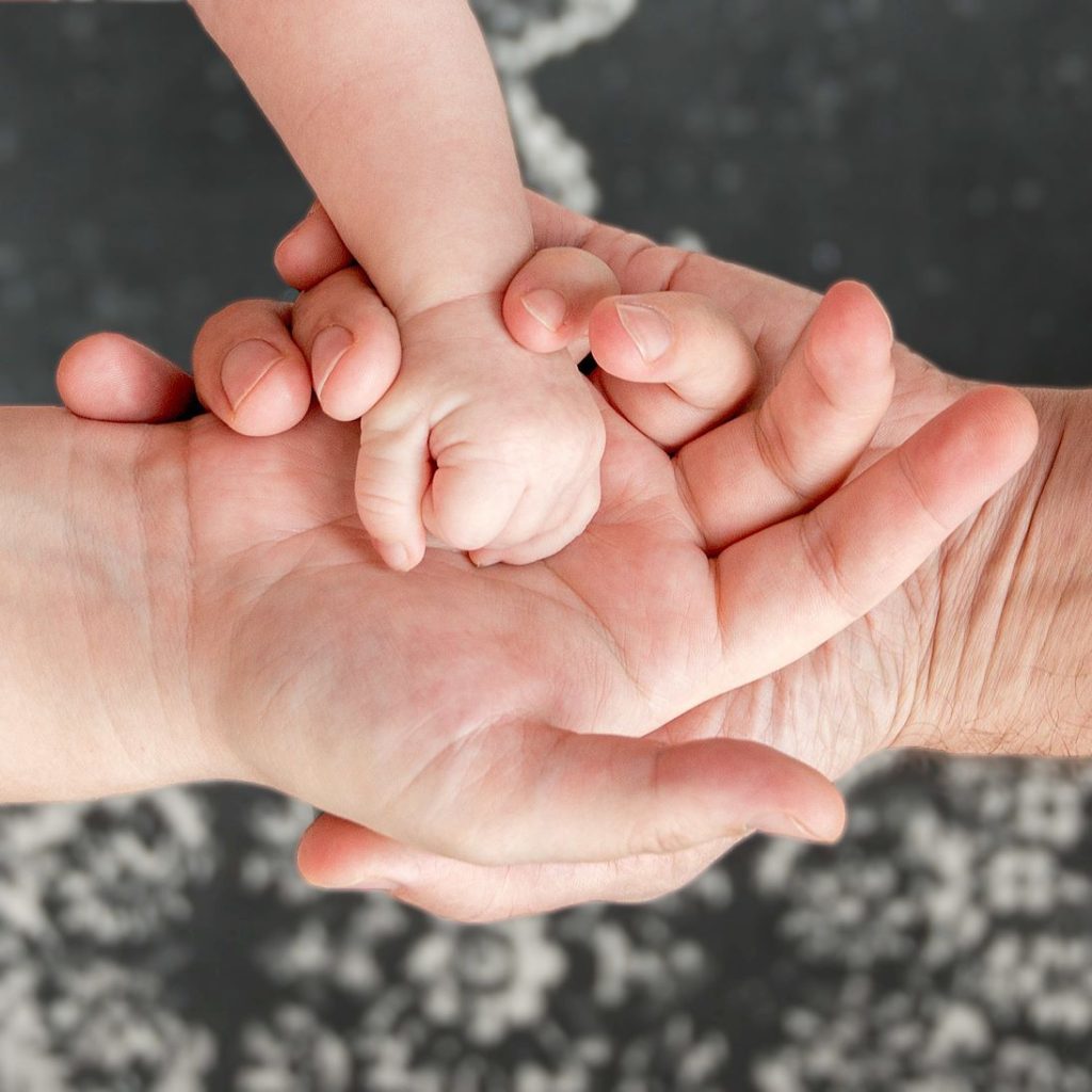 Three hands parents and kid child