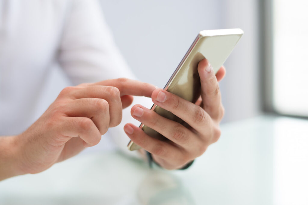 close up male hands using smartphone