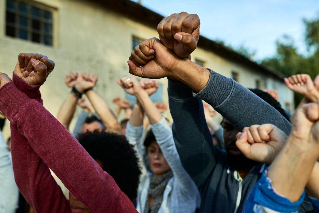 closeup multiethnic group protesters with armcrossing gesture public demonstrations