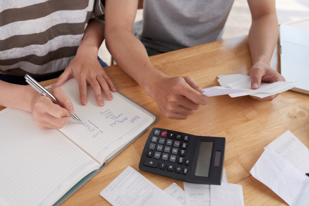 cropped unrecognizable people keeping records expenses