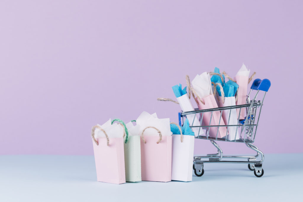 many colorful paper shopping bags cart