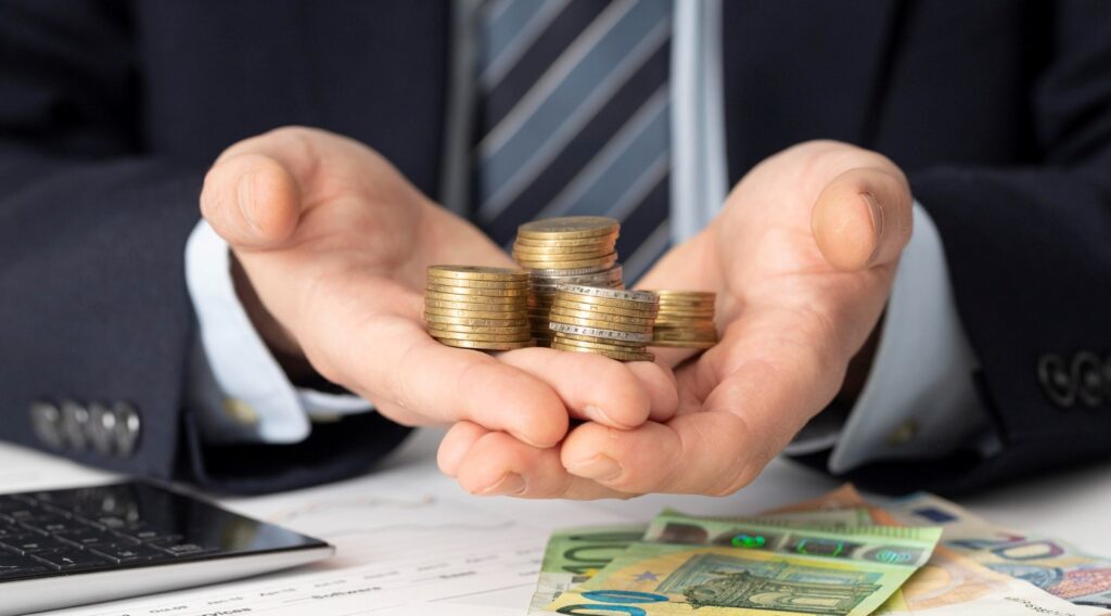 businessman holding bunch coins 1