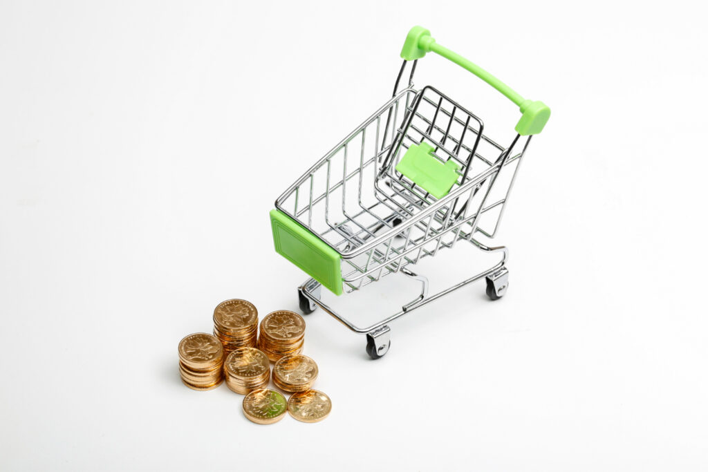 coins pile shopping cart white background