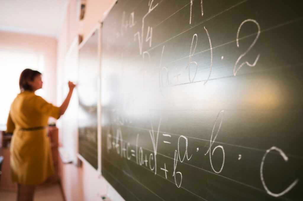 portrait teacher writing chalkboard