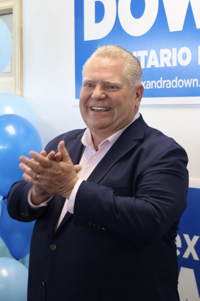 Doug Ford applauds at a PC campaign office cropped